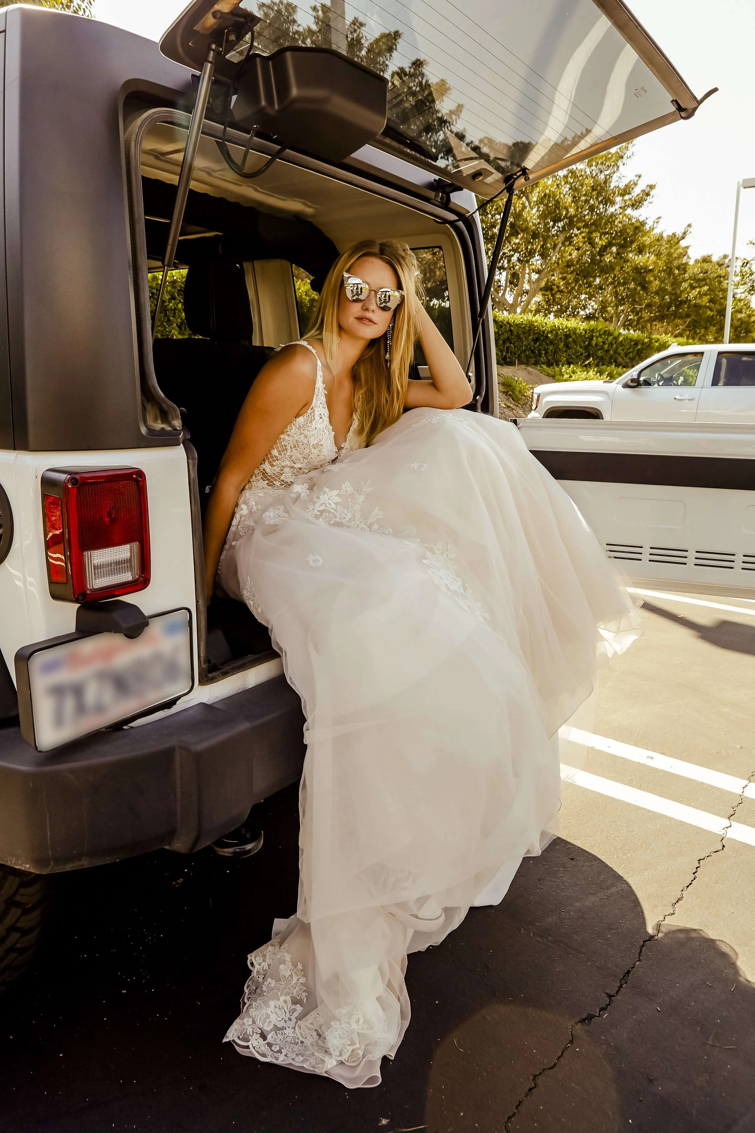 Moonlight style PB6732 wedding gown, bride sitting in the back of a Jeep