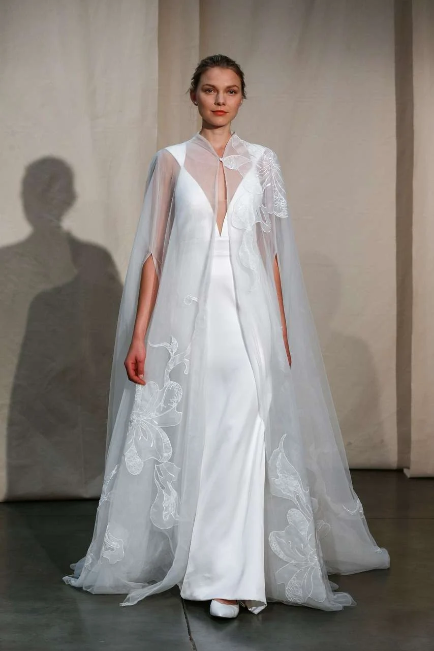 Justin Alexander Spring 2020 crepe gown with a plunging neckline and sheer cape