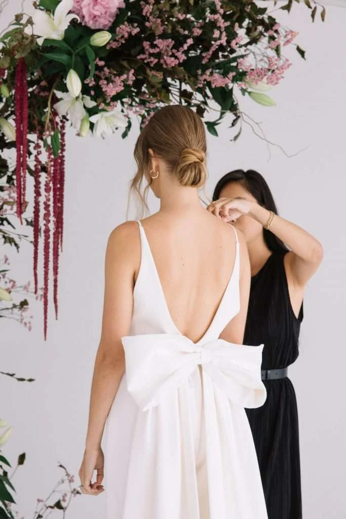 Trish Peng V-neck gown with a low bow-tied back beneath hanging florals