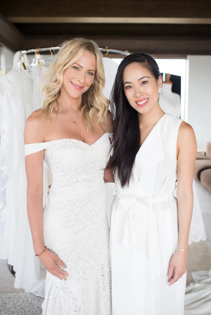 Designer Trish Peng with a model in an off-the-shoulder gown at a trunk show